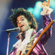 FILE - In this Feb. 18, 1985 file photo, Prince performs at the Forum in Inglewood, Calif. A pair of record labels announced Friday, April 28, 2017, that a remastered edition of Prince’s landmark 1984 album “Purple Rain” will be released on June 23, 2017. The labels say Prince oversaw the remastering process in 2015 and the “Purple Rain Deluxe” will include six previously unreleased songs by the late singer-songwriter, who died one year ago. (AP Photo/Liu Heung Shing, File)